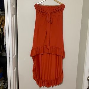 Large orange strapless high low sun dress.